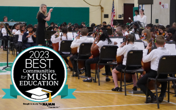 Intermediate school orchestra concert with the 2023 Best Communities for Music Education badge