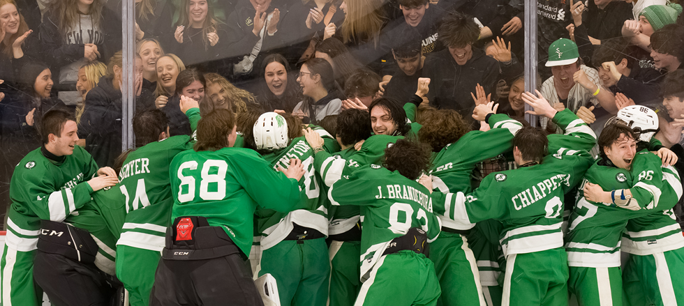 SF hockey team celebrates Pens Cup Championship while student section celebrates in the background